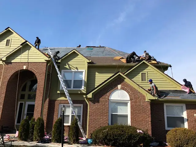Re-roof in progress on a brick home